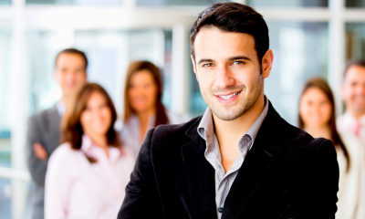 Male employer in a suit stood in front of a group of employees