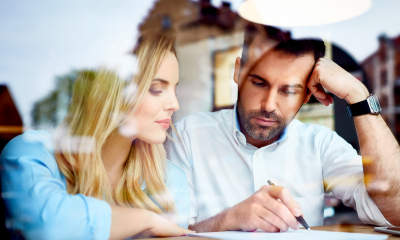 Managing your creditors Man and woman working through financial figures