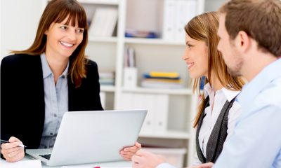 Business couple applying for grant funding with R&D credits in an office